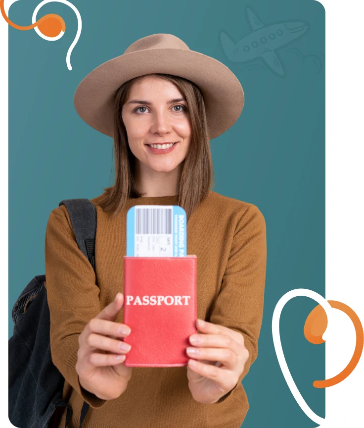 Smiling traveller in a hat holding up a passport with a boarding pass tucked inside